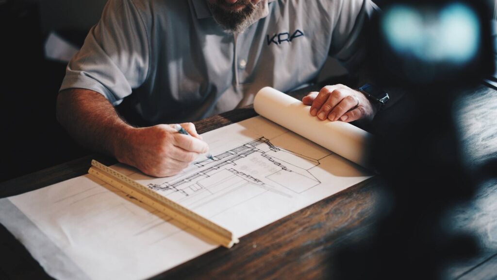 Designer at a studio workbench reviewing work in progress